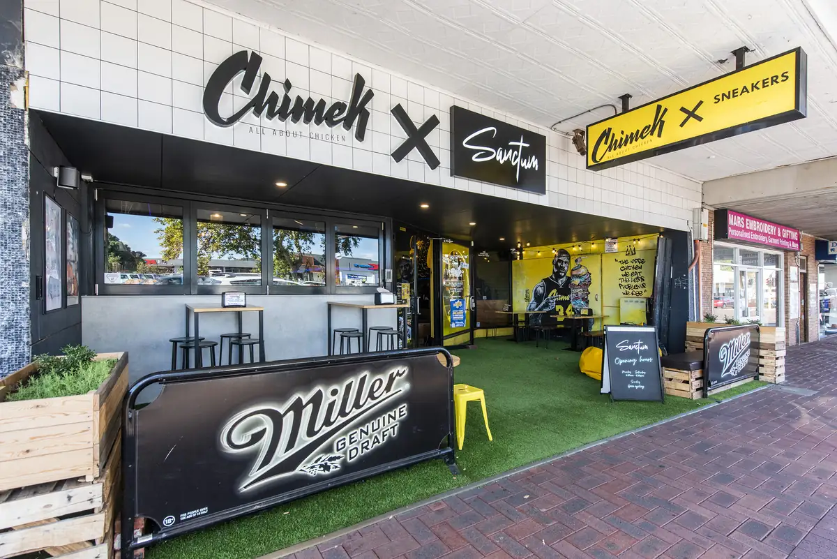 Sanctum Cafe &mdash; completed shopfront with signage, roller shutter and planter seating