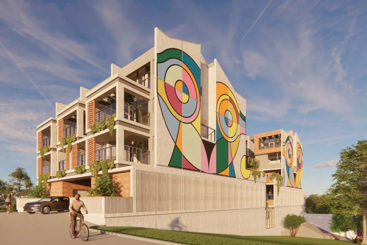 Regal Place mixed-use development — multi-storey facade in brick and render with a large colour mural over ground-floor commercial.